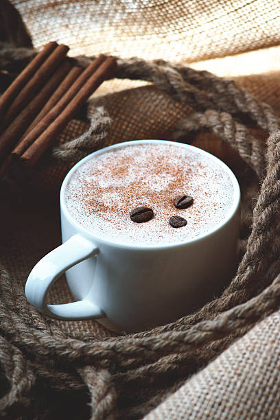 istock Cappuccino coffee cup,coffee beans, rope and cinnamon on burlap sack 482760530
