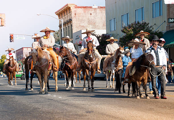 Panguipulli, Chile - September 17, 2014: A group of Huasos galloping his horses at the main avenue of the town for the commemoration of the Independence of Chile. Background people watching.