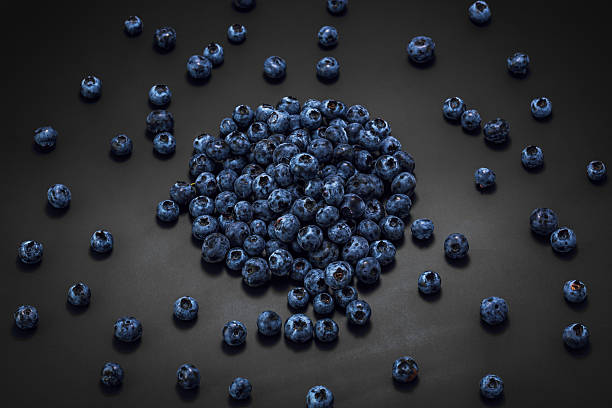 Wet blueberries on black slate