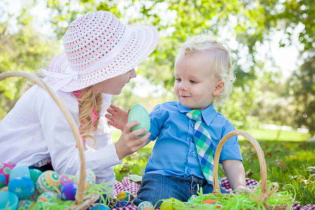 istock Cute Young Brother and Sister Enjoying Their Easter Eggs Outside 482764141