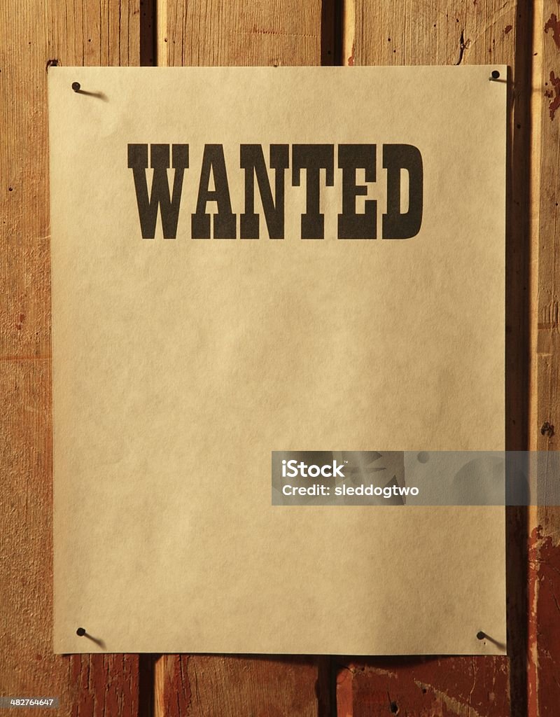 Wanted Poster The word, "Wanted" on some light brown parchment type paper on aged barn wood. The paper is otherwise blank. Blank Stock Photo