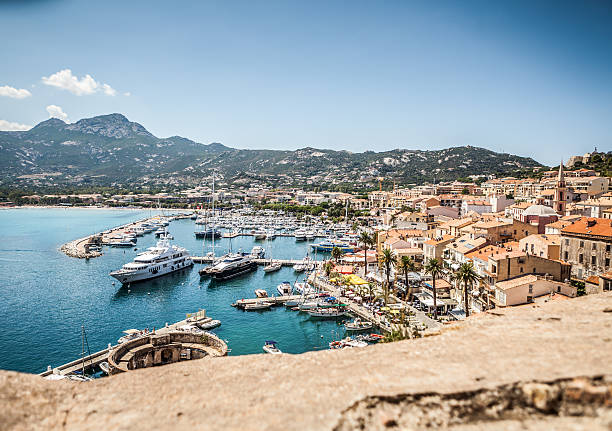 The village and touristic harbor of Calvi, Corsica Calvi, France - August 17, 2013: The village and touristic harbor of Calvi, Corsica, in a sunny summer day. Boats and yachts ready to salt at the dock. corsica photos stock pictures, royalty-free photos & images