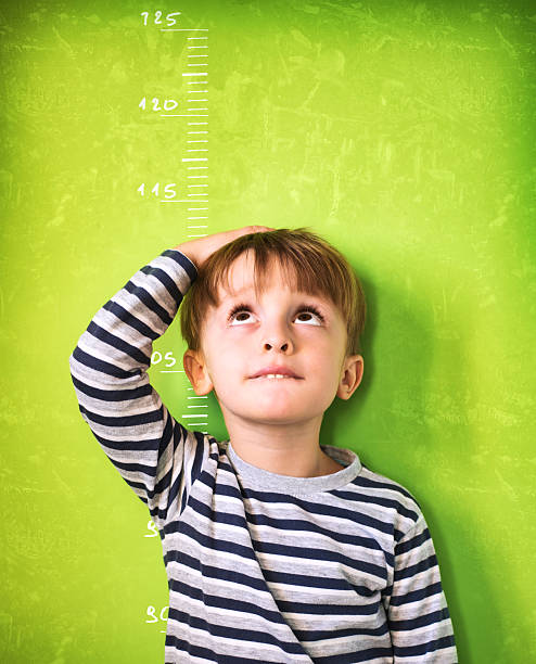 istock The growing child - Green Background 482765079