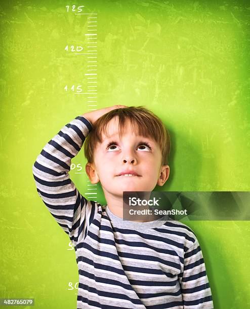 The Growing Child Green Background Stock Photo - Download Image Now - Child, Measuring, Instrument of Measurement