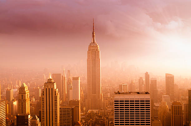 nyc skyline at sunset - empire state building stok fotoğraflar ve resimler