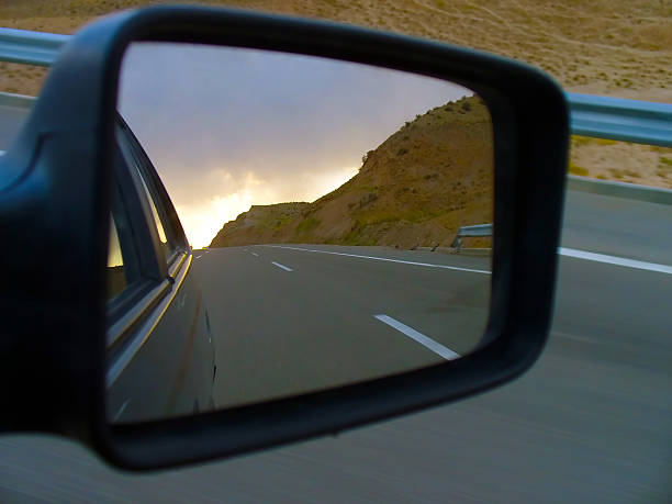 istock Road at dusk in car side view mirror 482765547