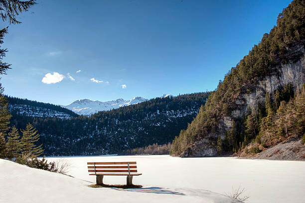 istock Bench at a frozen lake 482765675
