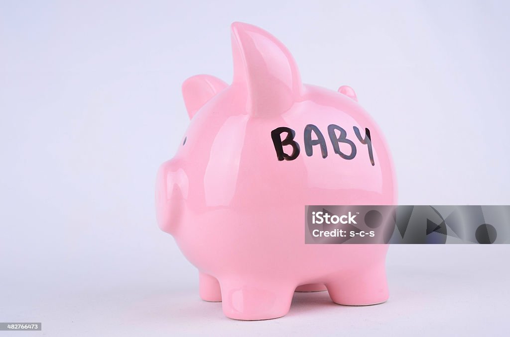 Saving for a Baby Baby written on the side of a piggybank Baby - Human Age Stock Photo