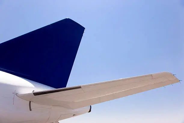 Empenage Detail, Airplane Tail of a Airbus Passenger Airplane against sunny blue sky.