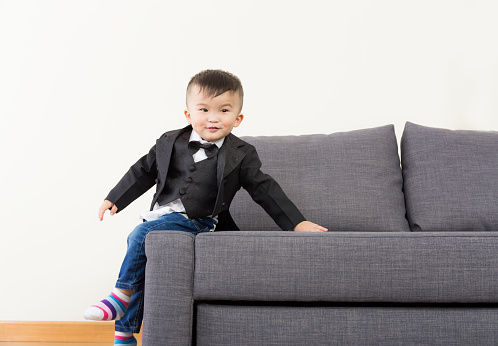 Little boy seating on sofa