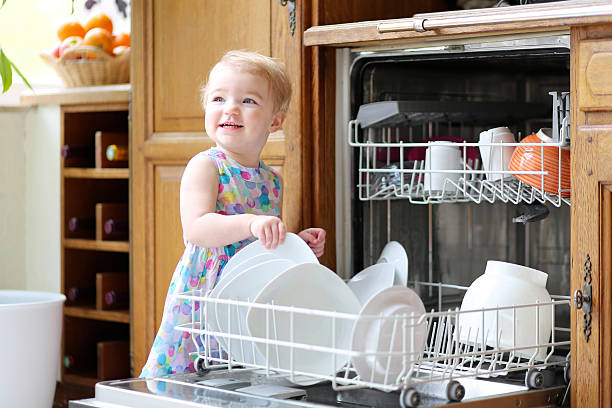 istock Toddler girl helps in the kitchen with dishes 482767227