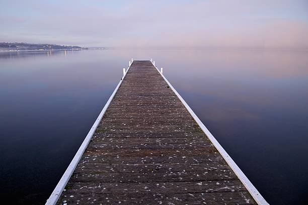 Jetty on a foggy morning stock photo