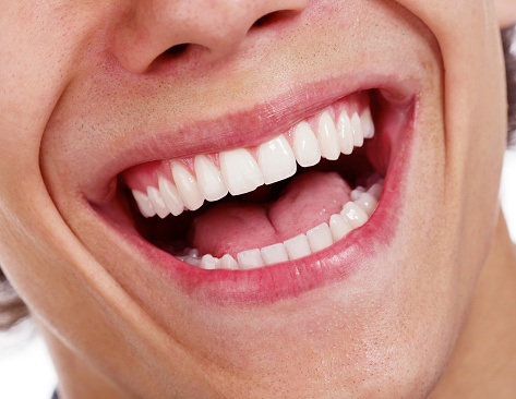 Closeup shot of awesome healthy teeth over white background