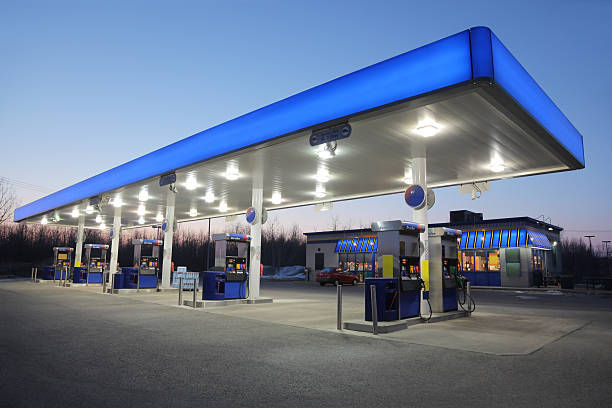 Illuminated Blue Gas Station at Sunset  buzbuzzer stock pictures, royalty-free photos & images