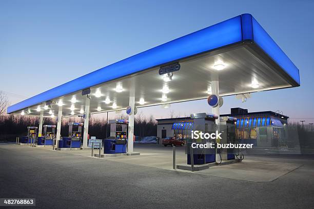 Illuminated Blue Gas Station At Sunset Stock Photo - Download Image Now - Gas Station, Convenience Store, Blue
