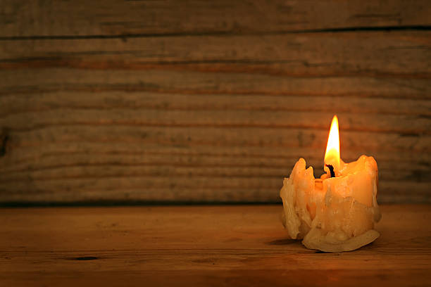 istock Burning old candle on wooden vintage background 482770168