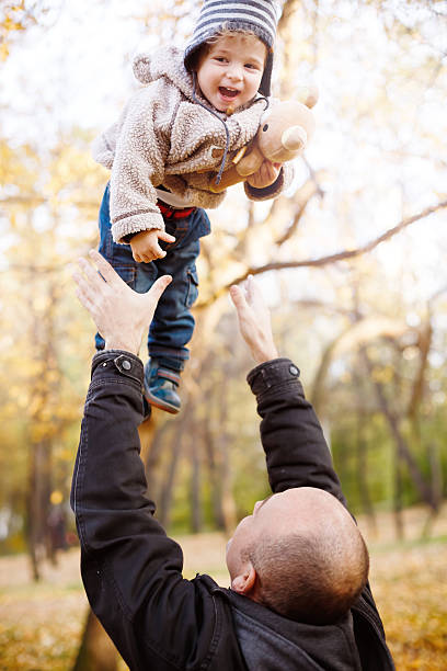 istock Father Playing with Son in the Autumn Park 482771038