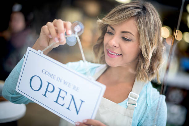 istock Business owner hanging an open sign at a store 482773490