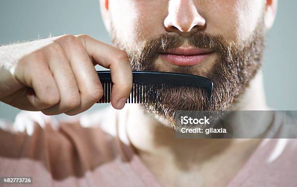 Unrecognizable Man Combing His Beard Stock Photo - Download Image Now - Beard, Men, Body Care