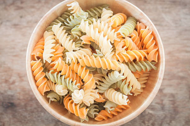 istock Fusili pasta in wooden plate 482775354