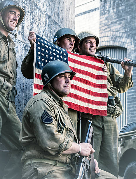 istock Proud WWII US Army Platoon Displaying American Flag 482777410