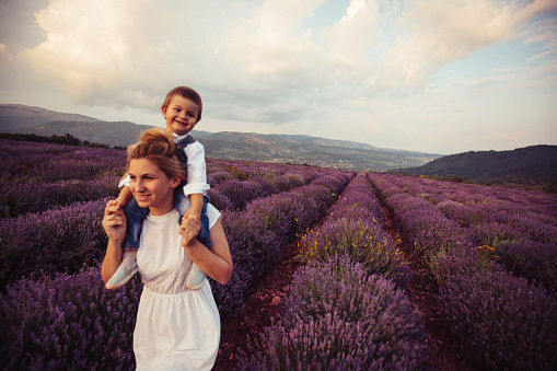 Photo of mother and her son having fun at the lavender field