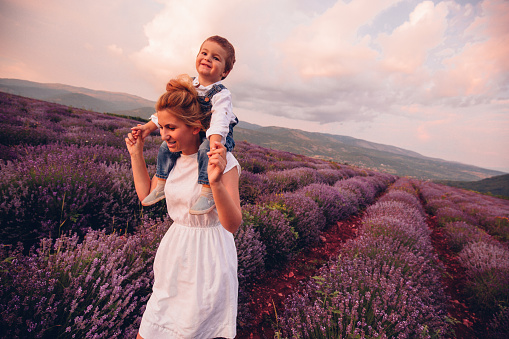 Photo of mother and her son having fun at the lavender field