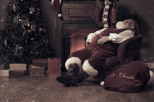 A real authentic Christmas photo of Santa Claus asleep in the living room.