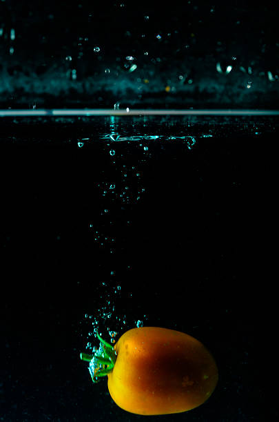 Tomato water splash on black background