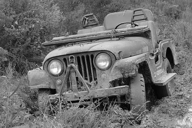 60's Willys Jeep bogged down in the mud.