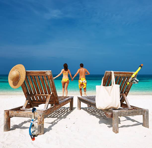 istock Couple in yellow running on a beach at Maldives 482784409