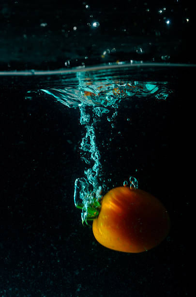 Tomato water splash on black background