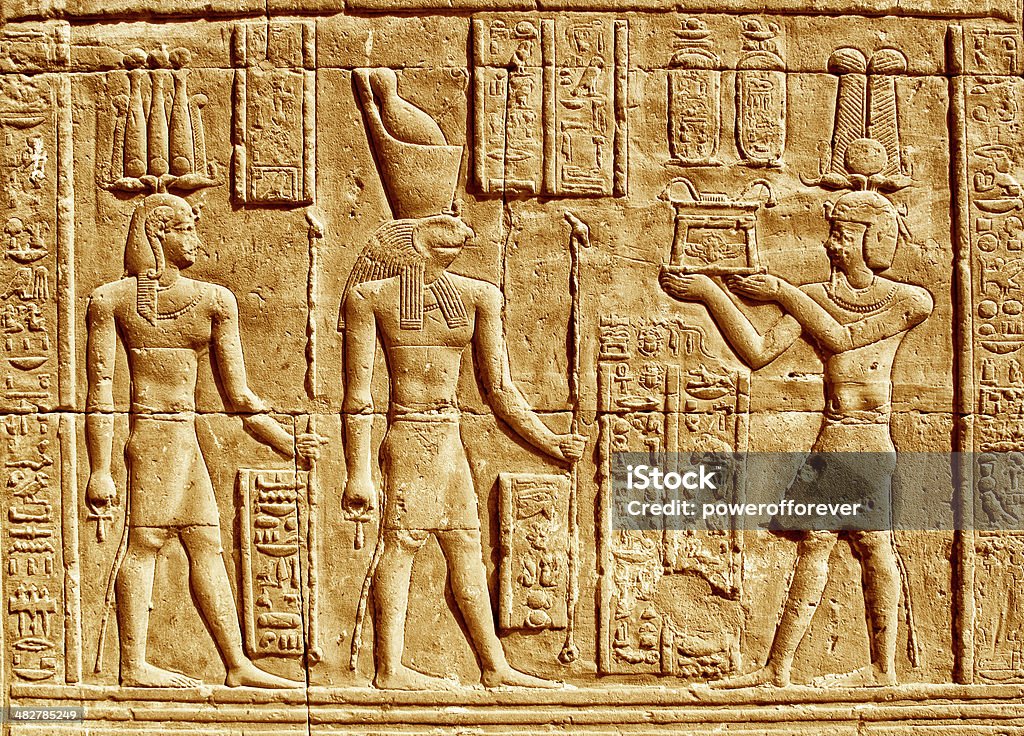 Ancient Hieroglyphics Ancient Hieroglyphics - Egyptian man making an offering to the god Horus. Ancient Egyptian Culture Stock Photo