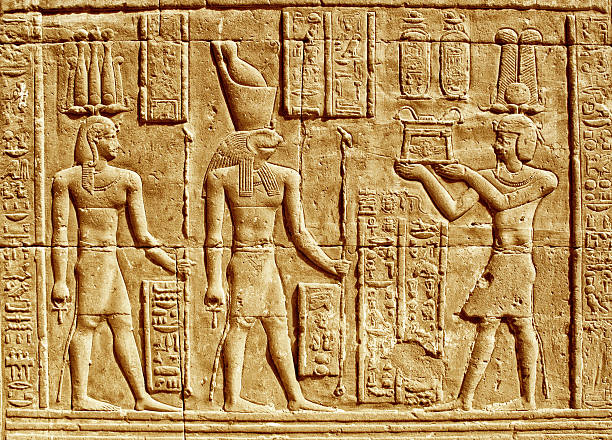 Ancient Hieroglyphics Ancient Hieroglyphics - Egyptian man making an offering to the god Horus. horus stock pictures, royalty-free photos & images