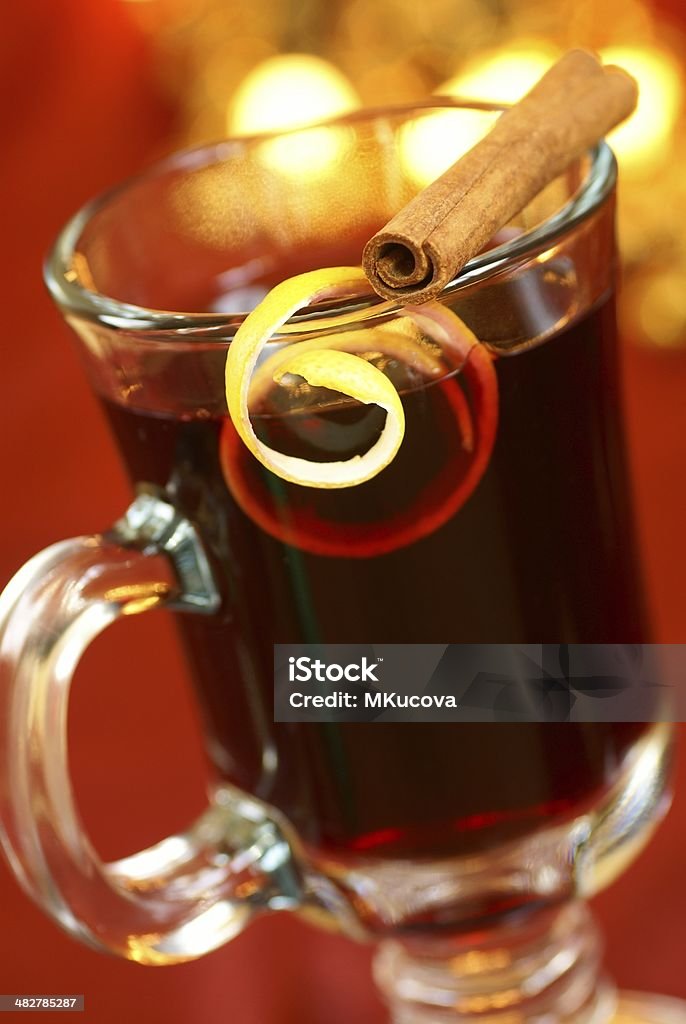 Mulled wine Mulled wine with lemon peel and cinnamone stick on glass. Selective focus, shallow DOF. Alcohol - Drink Stock Photo