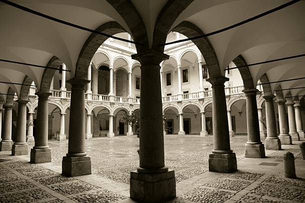 Palermo, Italy - February 3, 2012: Wide angle view of the colonnade of the inner courtyard of the \