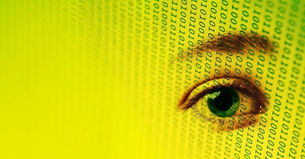 They're Watching Eye on binary code. Could signify "big brother", privacy, or retinal scanning big brother orwellian concept stock pictures, royalty-free photos & images