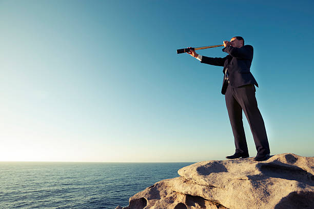 istock Businessman looking to the future with telescope 482786627