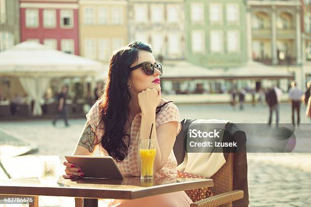 Young Woman Using A Digital Tablet In The Outdoor Restaurant Stock Photo - Download Image Now