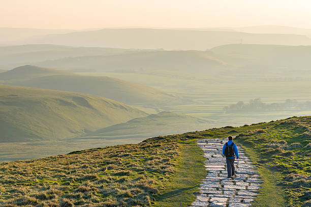 Walker/Hiker in the Peak District National Park, England A young male walking/hiking in the Peak District National Park, England, UK. peak district national park photos stock pictures, royalty-free photos & images