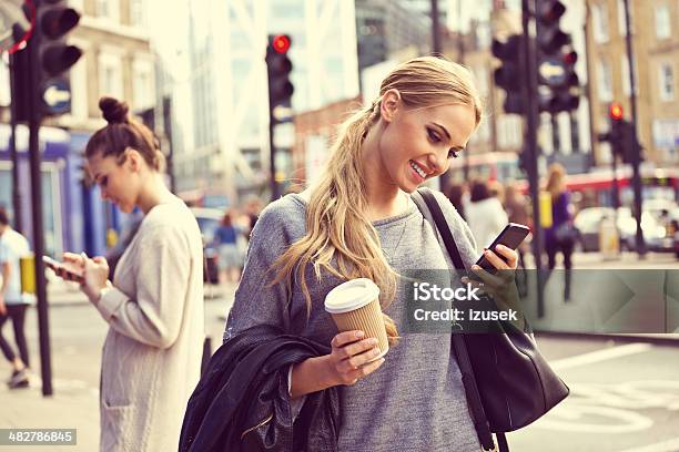 Young Woman In The City Stock Photo - Download Image Now - Stoplight, Blond Hair, Mobile Phone