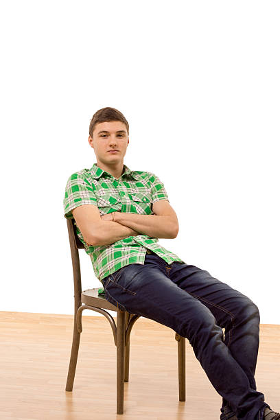 istock Confident young man sitting comfortably in a chair 482788765