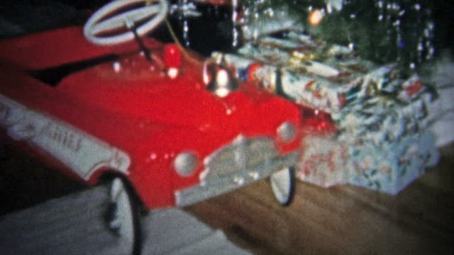 NEW HAVEN, CONN. USA - 1957: Kid playing with red fire truck Christmas gift.