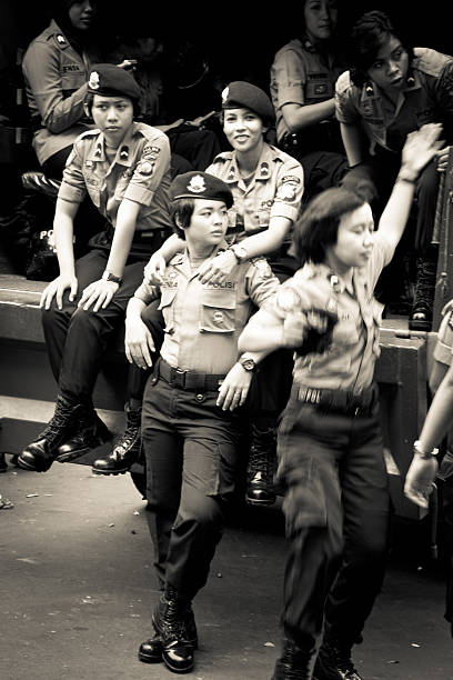 Police women riot training on the streets of Malang, Indonesia Malang, Indonesia - April 26, 2015: Indonesian police women of Malang practice riot training in the streets of Malang, Indonesia riot police stock pictures, royalty-free photos & images