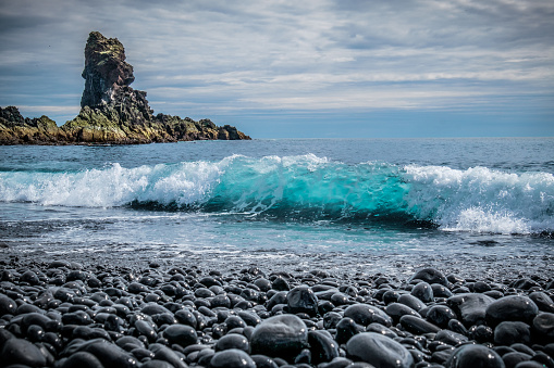 Black Pebbles and blue Wave at Djupalonssandur Beach, Snaefellsnes, Iceland