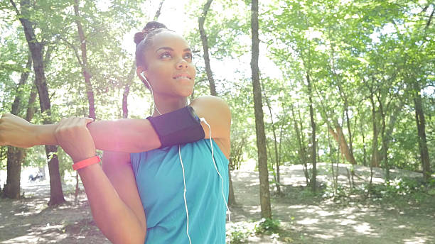 istock Young athletic woman stretching and warming up before running 482798632