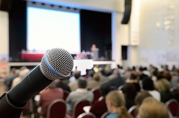 Microphone at conference. Dynamic microphone against the background of convention center. Real photo. large stock pictures, royalty-free photos & images