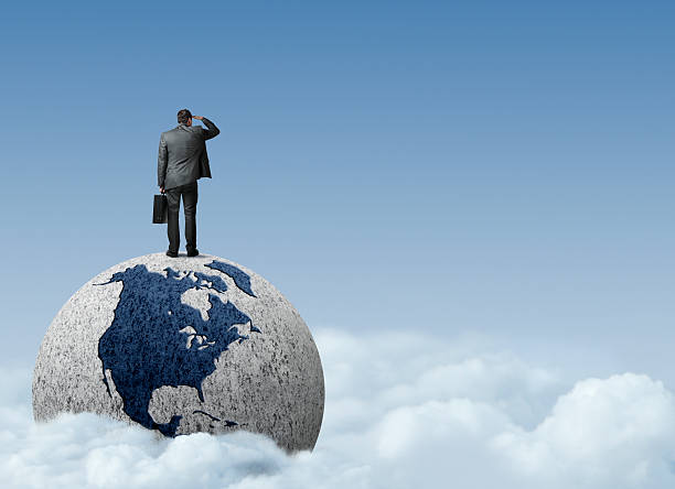 istock Businessman standing on top of globe looking into distance 482800691