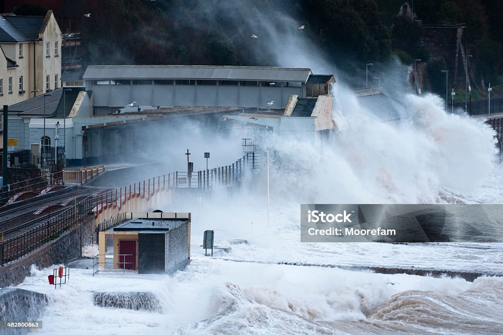 Huge waves breaking over Dawlish station in Devon Very high tides with a storm surge and gale force winds caused these huge seas at Dawlish that the next day led to the railway line being severely damaged and closed for several months. Storm Surge Stock Photo