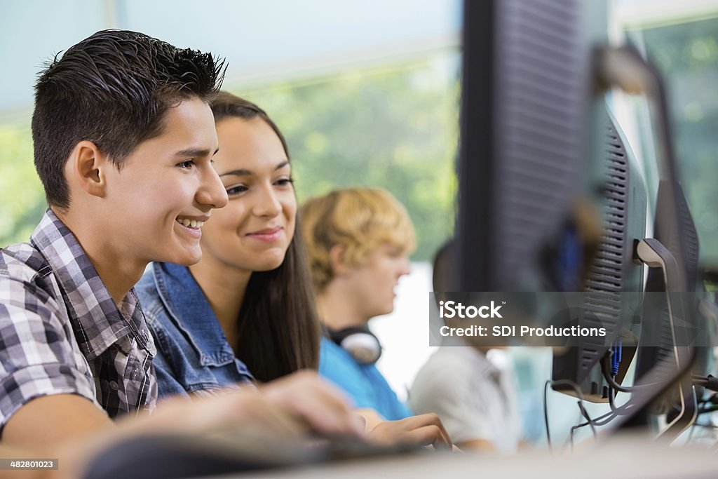 High School Students Working Together On Computer Class Assignment ...